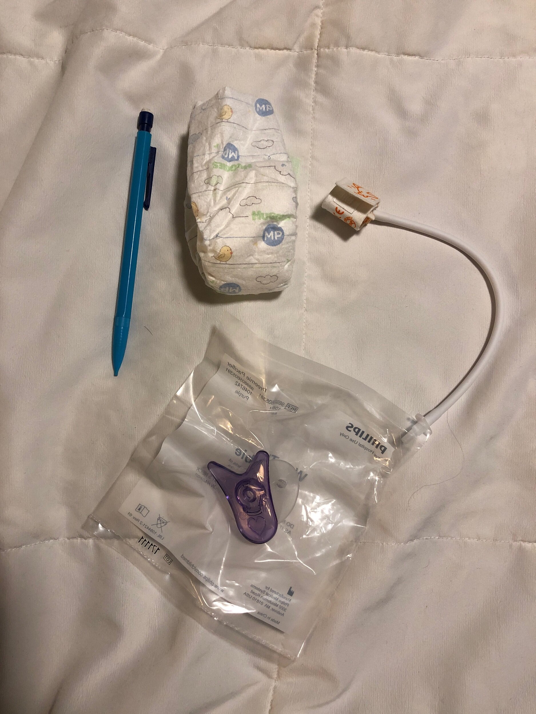 &nbsp;First diaper, blood pressure cuff, and pacifier